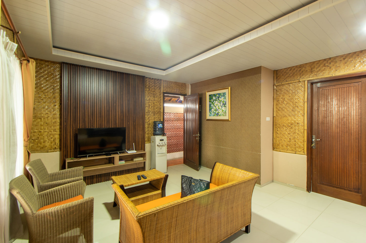 Ruang keluarga dengan kursi dan meja yang terbuat dari rotan serta dinding yang terbuat dari bilik anyaman bambu ini menjadikan suasan berkumpul di Villa menjadi hangat. Dilengkapi dengan Smart tv dan internet yang bisa kamu gunakan kapan saja.