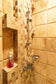 Shower dengan hand shower dan rak sabun di kamar mandi Villa Dago35